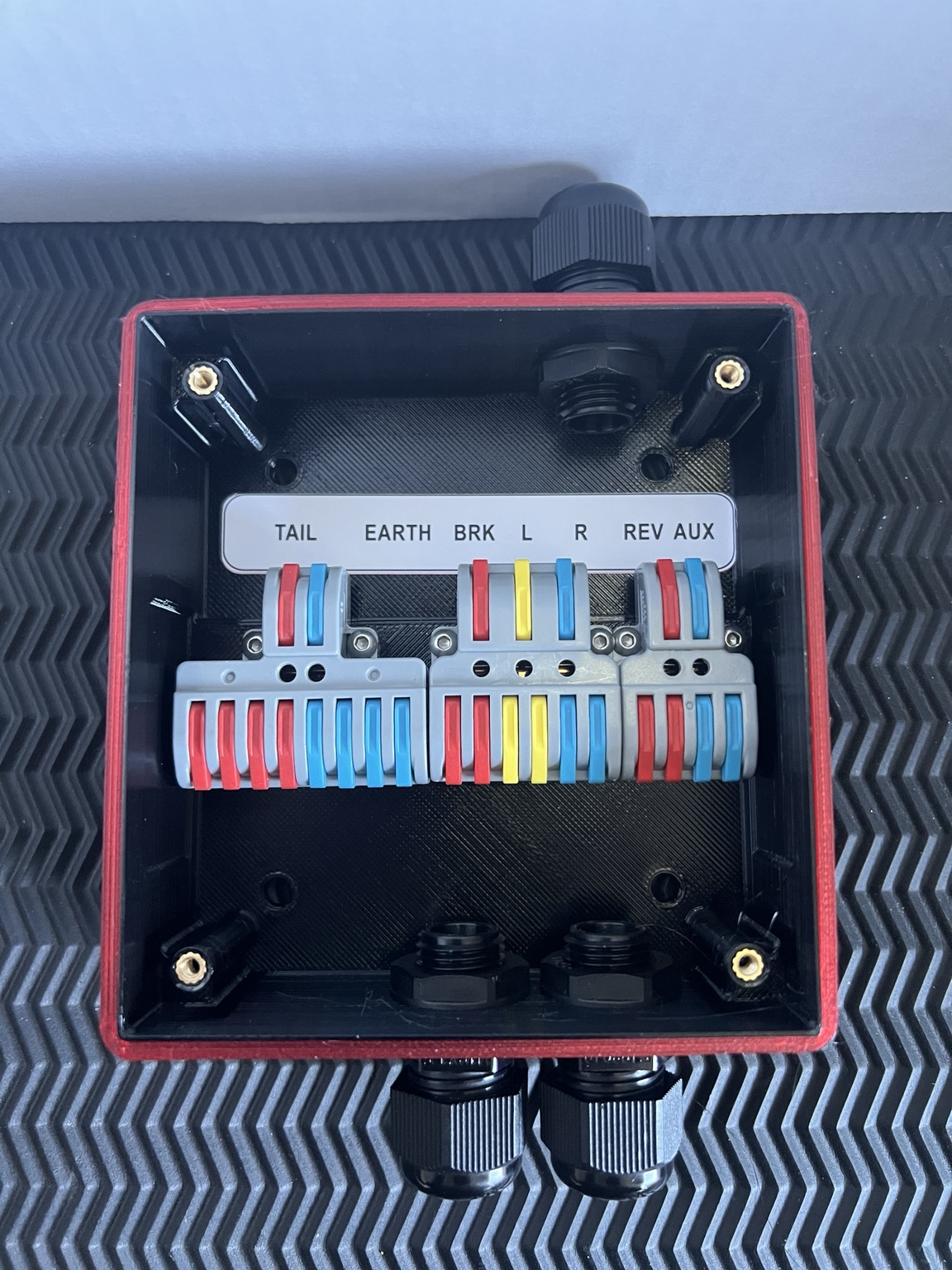 Inside a Flex Systems trailer junction box showing colour-coded lever terminals
